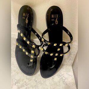 Sandals, gold studded flat black patent faux leather.